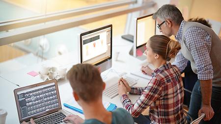Photoshop Bootcamp Students learning Photoshop and practicing in front of computers in Photoshop bootcamp course.