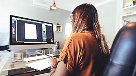 Adobe Illustrator bootcamp student working at a computer.