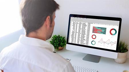 Student attending an Excel course looking at a spreadsheet on a computer screen.