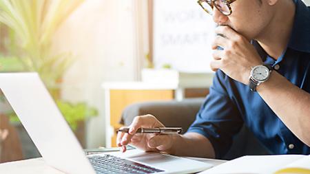 Student working at a computer attending a Power BI course online.